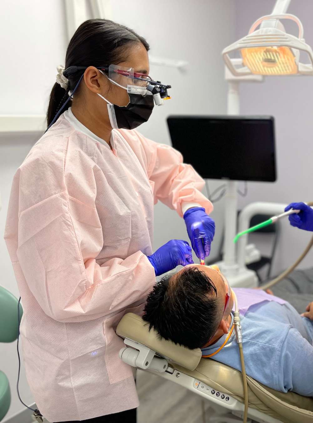Dentist with patient in dental chair